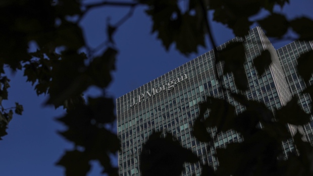 A sign sits on the of the U.K. offices of JPMorgan Chase & Co. bank in the Canary Wharf business, financial and shopping district of London, U.K., on Friday, Sept. 18, 2020. After a pause during lockdown, lenders from Citigroup Inc. to HSBC Holdings Plc have restarted cuts, taking gross losses announced this year to a combined 63,785 jobs, according to a Bloomberg analysis of filings.