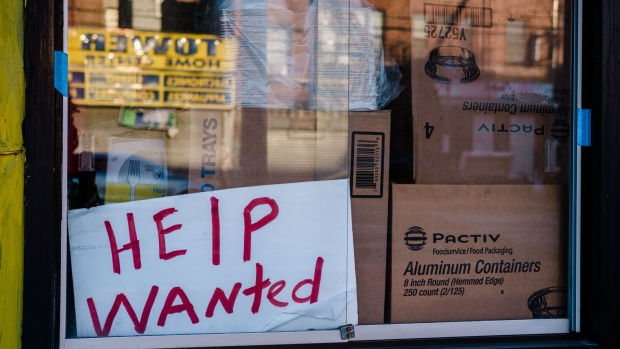 A "Help Wanted" sign outside a restaurant in the East Flatbush neighborhood in the Brooklyn borough of New York, U.S., on Monday, March 29, 2021.The U.S. economy is on a multi-speed track as minorities in some cities find themselves left behind by the overall boom in hiring, according to a Bloomberg analysis of about a dozen metro areas.