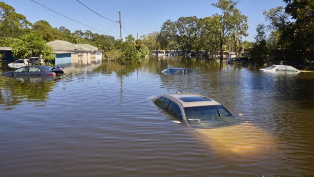 Vehicles and homes submerged in water in a flooded neighborhood following Hurricane Ian in Orlando, Florida, US, on Friday, Sept. 30, 2022. Two million electricity customers in Florida remained without power Friday morning, according to the tracking site poweroutage.us. Photographer: Brian Carlson/Bloomberg
