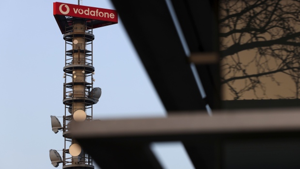 A Vodafone Group Plc logo on a telecommunications mast in Berlin, Germany, on Wednesday, Feb. 24, 2021. Vodafone plans to float a minority stake of its European towers unit Vantage Towers AG in Frankfurt, setting up what could be one of the region’s biggest initial public offerings this year. Photographer: Liesa Johannssen-Koppitz/Bloomberg