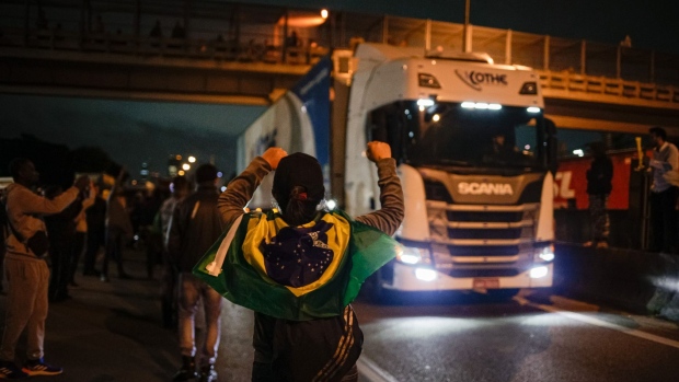 A truck drives past demonstrators during a protest on Castello Branco highway in Sao Paulo, on Nov. 1.