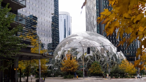 A delivery worker travels past the Amazon Spheres, part of the Amazon headquarters campus, in the South Lake Union neighborhood of Seattle, Washington, U.S., on Friday, Oct. 22, 2021. Concerns about Covid, crime and homelessness — and open warfare between the city government and parts of its lucrative tech and business sector — have emptied Seattle's commercial districts. Voters are hoping a new mayor will turn things around — but even though most are Democrats, they disagree on what change is needed.