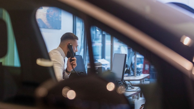 An employee speaks on the telephone in the showroom of an automobile dealership, operated by Pentagon Motor Group, a division of Motus Holdings Ltd., in Lincoln, U.K., on Wednesday, Oct. 21, 2020. As the earnings season picks up pace, an improving outlook for carmakers may further boost the sector thats already leading Europes stock rebound since March.