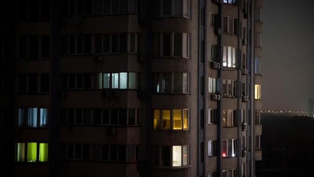 KYIV, UKRAINE - NOVEMBER 06: Apartment blocks stand in near total darkness during a scheduled power cut on the left bank of the River Dnipro November 06, 2022 in Kyiv, Ukraine. Electricity and heating outages across Ukraine caused by missile and drone strikes to energy infrastructure have added urgency preparations for winter. (Photo by Ed Ram/Getty Images)