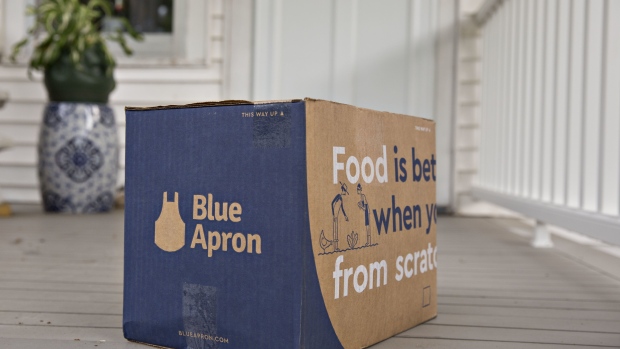 A Blue Apron Holdings Inc. meal-kit delivery package sits outside a home in this arranged photograph in Tiskilwa, Illinois, U.S., on Wednesday, June 14, 2017. Blue Apron Holdings Inc. filed for an initial public offering in the U.S., after reportedly delaying listing preparations while it worked to improve financials. Photographer: Daniel Acker/Bloomberg