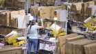 An employee packs boxes at the Amazon.com Inc. fulfilment centre in Tilbury, U.K. on Friday, July 12, 2019. By offering 12 extra hours of deals during this year's Prime Day, Amazon will pull in nearly 50% more in sales, according to an estimate from Coresight Research. Photographer: Jason Alden/Bloomberg