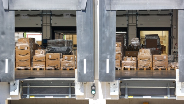 Packages featuring the Amazon.com Inc. logo sit in the loading bays at the Kuehne + Nagel International AG logistics center in Haiger, Germany, on Thursday, Aug. 6, 2020. Transport group Kuehne + Nagel’s first-half earnings beat estimates, aided by cost management as its revenue declined.