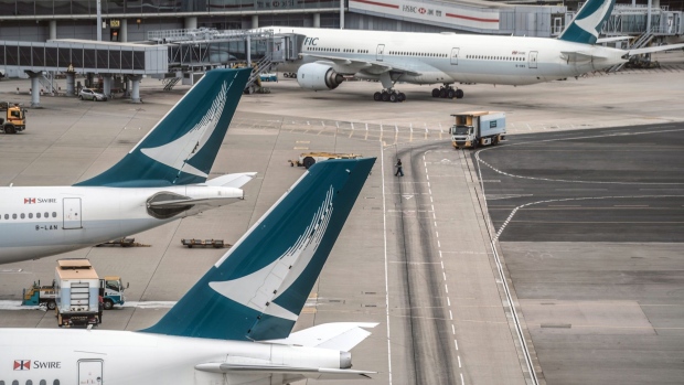 Aircraft operated by Cathay Pacific Airways Ltd. at Hong Kong International Airport in Hong Kong, China, on Tuesday, Nov. 1, 2022. Hong Kong International Airport opened a bridge connecting a terminal and satellite concourse on Tuesday, part of a wider HK$9 billion ($1.15 billion) upgrade even as a full recovery in air traffic remains far off. Photographer: Lam Yik/Bloomberg