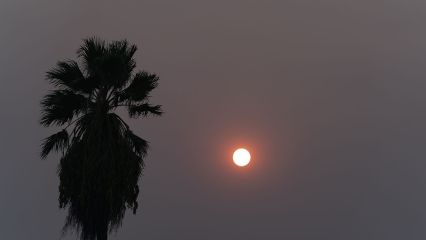 The sun is obscured by smoke from wildfires in Fresno, California, U.S., on Thursday, Aug. 20, 2020. More than 360 blazes are burning in California, forcing mass evacuations in the northern part of the state and creating an air quality emergency. Photographer: Alex Edelman/Bloomberg