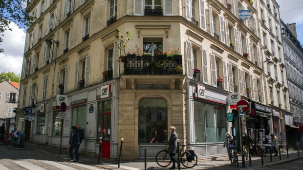 Pedestrians pass a Credit Agricole SA bank branch in Paris, France, on May 7, 2021. Credit Agricole’s profits jumped in the first quarter, as the bank joined European peers in posting a strong trading performance and lower-than-anticipated charges to cover potential loan losses.