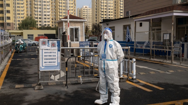 A worker in protective gear at a neighborhood placed under lockdown due to Covid-19 in Beijing, China, on Thursday, Nov. 10, 2022. Chinese stocks dropped as the nation increased Covid restrictions to curb an outbreak in a key manufacturing hub, dampening hopes of a reopening that have triggered a rally this month.