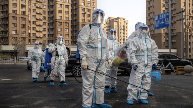 Workers in protective gear at a neighborhood placed under lockdown due to Covid-19 in Beijing, China, on Thursday, Nov. 10, 2022. Chinese stocks dropped as the nation increased Covid restrictions to curb an outbreak in a key manufacturing hub, dampening hopes of a reopening that have triggered a rally this month.