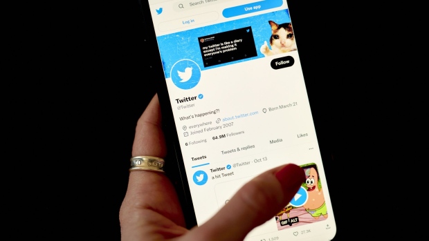 A blue verification check on the page of Twitter Inc. on a smartphone arranged in the Brooklyn borough of New York, US, on Monday, Nov. 7, 2022. Elon Musk’s agreement to buy Twitter Inc. is sending some users searching for alternative platforms — with mixed success.