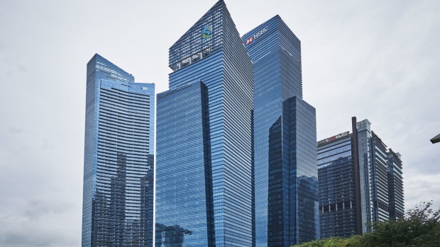 Towers that house the HSBC Holdings Plc headquarters, center right, the Standard Chartered Plc headquarters, center left, and other banks and financial institutions in the central business district (CBD) of Singapore, on Thursday, Jan. 28, 2021. HSBC plans to accelerate its expansion across Asia in its imminent strategy refresh, Chairman Mark Tucker told the virtual Asian Financial Forum last week.