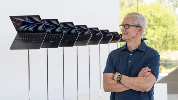 Tim Cook, chief executive officer of Apple Inc., next to a display of the new MacBook Air laptop computers during the Apple Worldwide Developers Conference in Cupertino, California, US, on Monday, June 6, 2022. Apple unveiled the most significant overhaul to its popular MacBook Air laptop in more than a decade, bringing a fresh design, new colors and a speedier M2 processor from its homegrown chip line.
