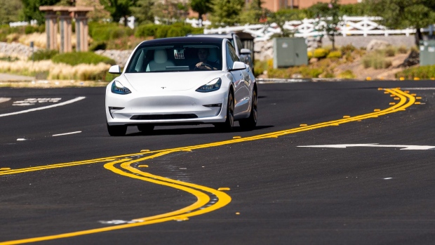A Tesla Model 3 travels on a road in Rocklin, California, U.S., on Wednesday, July 21, 2021. Tesla Inc. is scheduled to release earnings figures on July 26. Photographer: David Paul Morris/Bloomberg