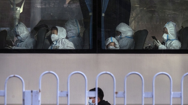 Passengers, including children, wear protective clothing inside a bus in Beijing on Nov. 15.