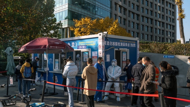 Residents at a Covid-19 testing booth in Beijing, China, on Monday, Nov. 14, 2022. A surge in Covid cases threatens to turn into an early test of China’s resolve to ease some of its strict virus controls, after health officials on the weekend said the changes were a refinement, not a relaxation, of the rules.