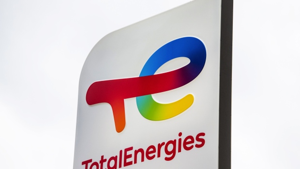 A logo at the TotalEnergies SE electric vehicle fuelling station in the La Defense business district in Paris, France, on Monday, July 12, 2021. French energy giant TotalEnergies will probably aim to cut the carbon emissions of its clients at a faster pace by 2030 if the European Union adopts more ambitious regulations to fight global warming, Chief Executive Officer Patrick Pouyanne said. Photographer: Nathan Laine/Bloomberg