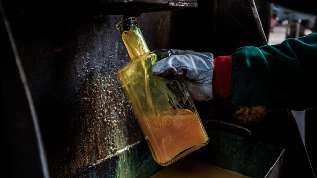 An employee collects a sample of light refined diesel fuel for quality control testing at a facility in the Duna oil refinery, operated by MOL Hungarian Oil & Gas Plc, in Szazhalombatta, Hungary, on Monday, Feb. 13, 2019. Oil traded near a three-month high as output curbs by OPEC tightened global supply while trade talks between the U.S. and China lifted financial markets. Photographer: Akos Stiller/Bloomberg