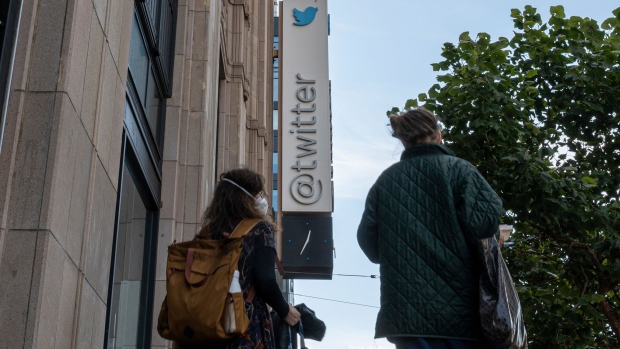Pedestrians outside Twitter headquarters in San Francisco, California, US, on Thursday, Oct. 6, 2022. Stock markets are still not entirely sold on Elon Musk's $44 billion takeover of Twitter Inc. after the billionaire revived the deal at its original price earlier this week. Photographer: David Paul Morris/Bloomberg