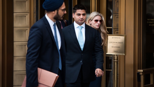 Rohan Ramchandani, former trader at Citigroup Inc., center, leaves federal court in New York, U.S., on Monday, July 17, 2017. Three former British currency traders touched down in New York over the weekend to face charges that they conspired to rig the foreign-exchange market.
