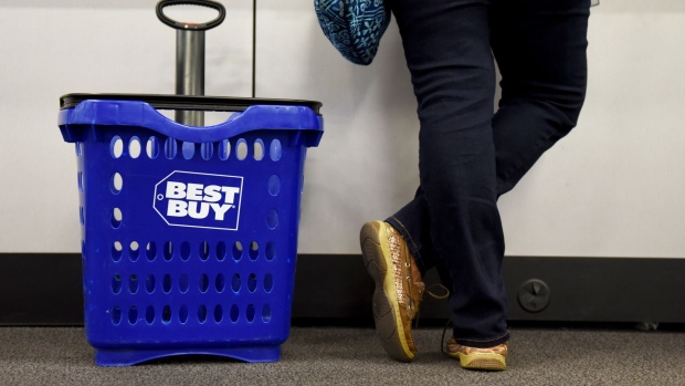 A customer stands next to a shopping basket at the check out counter of a Best Buy Co. store in San Antonio, Texas, U.S., on Thursday, May 17, 2018. Best Buy Co. is scheduled to release earnings figures on May 24.