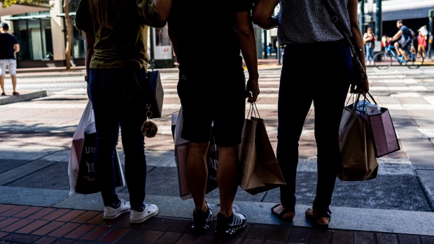 Shoppers carry bags in San Francisco, California, US, on Thursday, Sept. 29, 2022. US consumer confidence rose for a second month in September to the highest since April, indicating a strong job market and lower gas prices are contributing to more optimistic views of the economy.