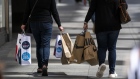 Pedestrians carry shopping bags in San Francisco, California, US, on Wednesday, May 18, 2022. US retail sales grew at a solid pace in April, reflecting broad-based gains and suggesting demand for merchandise remains resilient despite rampant inflation.