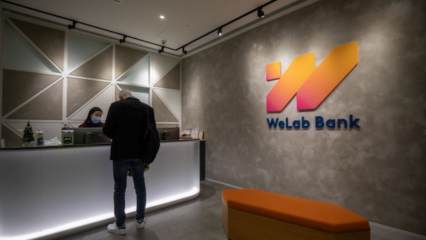 The WeLab Ltd. logo at the company's headquarters in Hong Kong, China, on Monday, Dec. 13, 2021. WeLab, backed by investors including Sequoia Capital and billionaire Li Ka-shing, is buying a controlling stake in a commercial bank in Indonesia, securing a foothold in one of Asia’s most under-served banking markets. Photographer: Paul Yeung/Bloomberg
