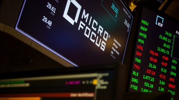Micro Focus International PLC signage is displayed on a monitor on the floor of the New York Stock Exchange (NYSE) in New York, U.S., on Friday, Sept. 1, 2017. U.S. stocks rose and Treasuries declined as reports showing a gain in consumer sentiment and a rise in manufacturing offset a mediocre August employment report. Photographer: Michael Nagle/Bloomberg