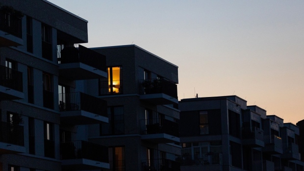 Lights on in a home within a block of apartments at dusk in Berlin, Germany, on Tuesday, Aug. 16, 2022. Germany's government has asked citizens, municipalities and industrial consumers to save energy, and efforts can be seen across the country. Photographer: Krisztian Bocsi/Bloomberg