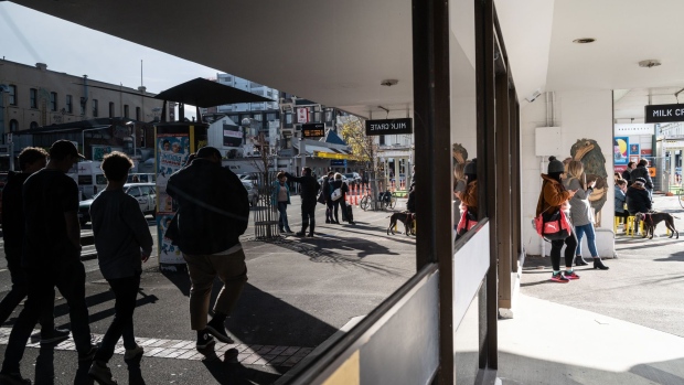 Pedestrians are reflected in a store window while walking along a sidewalk in Wellington, New Zealand, on Saturday, June 22, 2019. The out-of-favor kiwi dollar has tumbled about 3% this quarter as the Reserve Bank of New Zealand turned dovish and cut interest rates, the first central bank in the developed world to do so. Economic growth held at a five-year low in the three-months through March, leaving the door open for further easing. Photographer: Birgit Krippner/Bloomberg