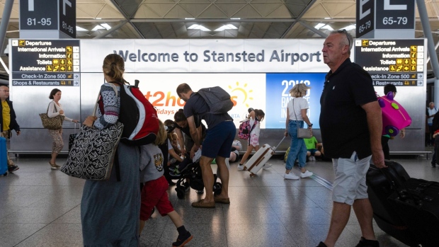 Passengers walk through London Stansted Airport, operated by Manchester Airport Plc, in Stansted, U.K., on Monday, July 25, 2022. Ryanair Holdings Plc said passengers remain cautious about booking, clouding its prospects beyond a summer travel boom in which it’s suffering less disruption than many of its rivals.