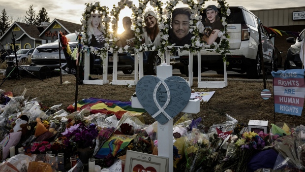 Mourners lay flags in remembrance at a memorial outside of Club Q on November 22, 2022 in Colorado Springs, Colorado. 