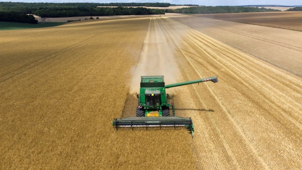 A Deere & Co. John Deere combine harvester cuts through a field of barley during the harvest in Ailly-sur-Noye, France, on Tuesday, June 28, 2022. Global grain supplies suffered from erratic weather worldwide and as Russia’s invasion of Ukraine choked shipments from one of the world's top exporters.