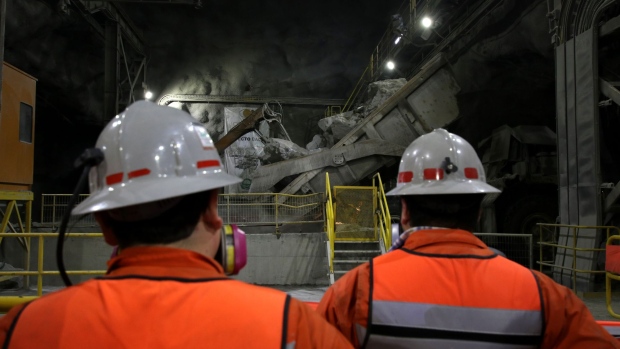 Employees stand inside the Codelco Metals Inc. Teniente copper mine near Rancagua, Chile, on Wednesday, March 21, 2018. Codelco chief executive officer and mining veteran Nelson Pizarro has spent more than half a century working in mines and has dedicated the last four years to turning the world's largest copper producer into a profitable company.