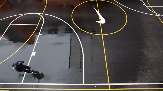 BEAVERTON, OR - MARCH 22: An employee speaks on a mobile phone as he strolls past a swoosh on a basketball court at the Nike headquarters on March 22, 2018 in Beaverton, Oregon. Nike, the world's largest sports brand, reported better than anticipated earnings on Thursday, with revenues increasing to nearly $90 billion. This follows a spate of senior executives stepping down amid reports of sexist behavior including the president on Nike Brand, Trevor Edwards. (Photo by Natalie Behring/Getty Images)