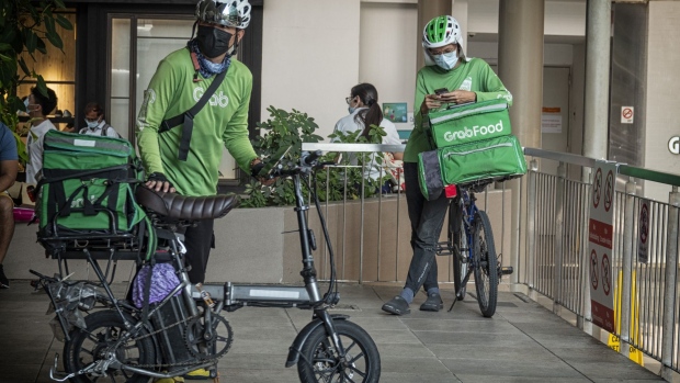 A GrabFood delivery rider in Singapore, on Wednesday, May 18, 2022. Grab Holdings Ltd., is expected to report results on May 19. Photographer: Bryan van der Beek/Bloomberg