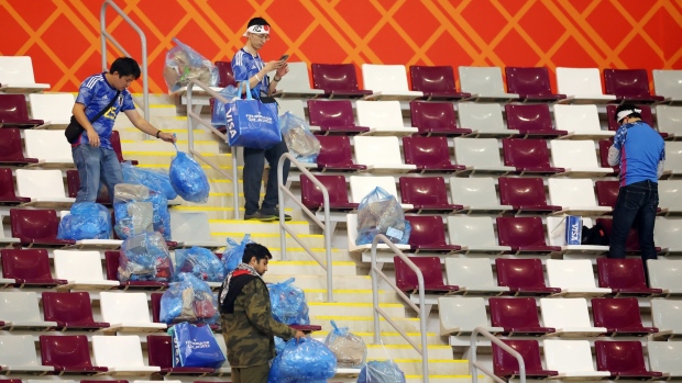 DOHA, QATAR - NOVEMBER 23: A Japanese fan clears rubbish from the stands during the FIFA World Cup Qatar 2022 Group E match between Germany and Japan at Khalifa International Stadium on November 23, 2022 in Doha, Qatar. (Photo by Alex Grimm/Getty Images) Photographer: Alex Grimm/Getty Images Europe