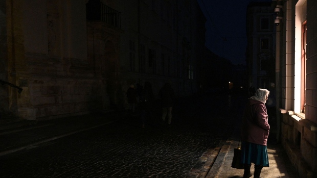 A woman walks on a street during a blackout after Russian attacks in the Western Ukrainian city of Lviv on November 23, 2022, amid the Russian invasion of Ukraine.  Photographer: Yuriy Dyachyshyn/AFP/Getty Images
