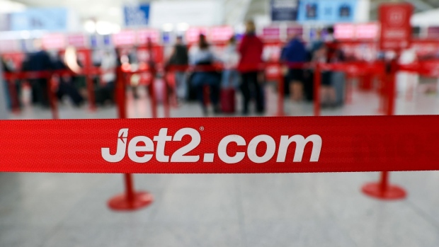 A Jet2 Plc sign at the check-in area at London Stansted Airport, operated by Manchester Airport Plc, in Stansted, U.K., on Monday, July 5, 2021. Jet2 will be making their next earnings announcement on July 8. Photographer: Chris Ratcliffe/Bloomberg
