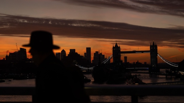 A commuter passes Tower Bridge in the City of London, UK, on Monday Oct. 3, 2022. Traders are the most negative ever on the pound’s prospects, even after the UK government scrapped one of its new tax policies, a sign it will take a bigger policy U-turn to restore credibility with markets. Photographer: Carlos Jasso/Bloomberg