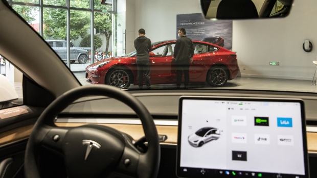 Customers at a Tesla Inc. showroom in Shanghai, China, on Sunday, Oct. 16, 2022. Tesla is scheduled to release third-quarter earnings results on Oct. 19. Photographer: Qilai Shen/Bloomberg