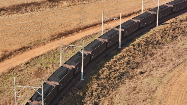 Freight wagons transport coal from the Mafube open-cast coal mine, operated by Exxaro Resources Ltd. and Thungela Resources Ltd., towards Richard's Bay coal terminal, in Mpumalanga, South Africa on Thursday, Sept. 29, 2022. South Africa relies on coal to generate more than 80% of its electricity, and has been subjected to intermittent outages since 2008 because state utility Eskom Holdings SOC Ltd. can't meet demand from its old and poorly maintained plants. Photographer: Waldo Swiegers/Bloomberg