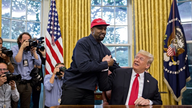 Rapper Kanye West, left, shakes hands with U.S. President Donald Trump during a meeting in the Oval Office of the White House in Washington, D.C., U.S., on Thursday, Oct. 11, 2018. West, a recording artist and prominent Trump supporter, is at the White House to have lunch with the president and to meet with presidential son-in-law and senior adviser Jared Kushner who has spearheaded the administrations efforts overhaul the criminal justice system.