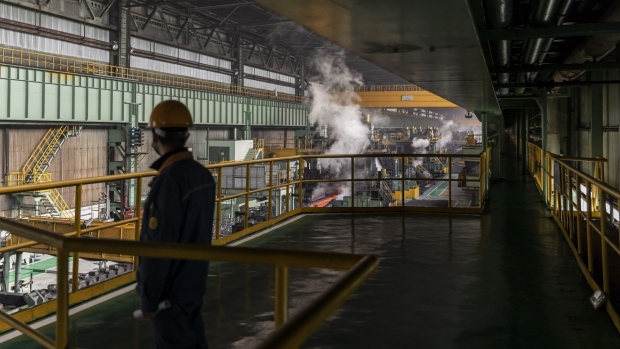 An employee stands on a platform overlooking the hot-rolling workshop at Baowu Steel Group's Baoshan production facility in Shanghai, China, on Tuesday, Jan. 18, 2022. Baowu, China's national steel champion created by the merger of Shanghai Baosteel Group and Wuhan Iron & Steel Group in 2016, has been expanding by acquiring smaller peers since 2019. Photographer: Qilai Shen/Bloomberg