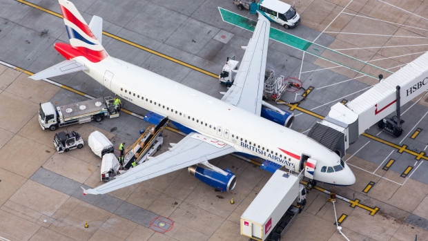 Luggage is loaded onto a passenger aircraft, operated by British Airways, a unit of International Consolidated Airlines Group SA (IAG), at London Gatwick airport in this aerial view taken over Crawley, U.K., on Monday, Oct. 24, 2016. The U.K. government will decide next week whether to expand London's main airport, Heathrow, or its rival Gatwick putting an end to decades of prevarication over what has become one of the most contentious issues in British politics.