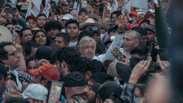 Andres Manuel Lopez Obrador, Mexico's president, center, greets attendees during a rally in support of the proposed electoral reform in Mexico City, Mexico, on Sunday, Nov. 27, 2022. AMLO took thousands of Mexicans to the streets for the first time since he took office in 2018, celebrating the upcoming fourth anniversary of his rule.