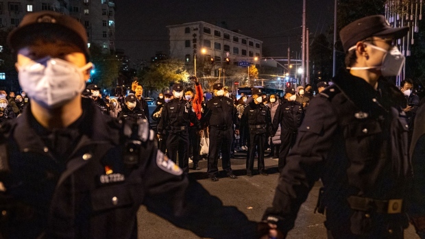 Police officers stand guard during a protest in Beijing. Source: Bloomberg/Bloomberg